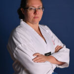 Sarah Powell, Blue Belt, Standing arms folded looking at the camara